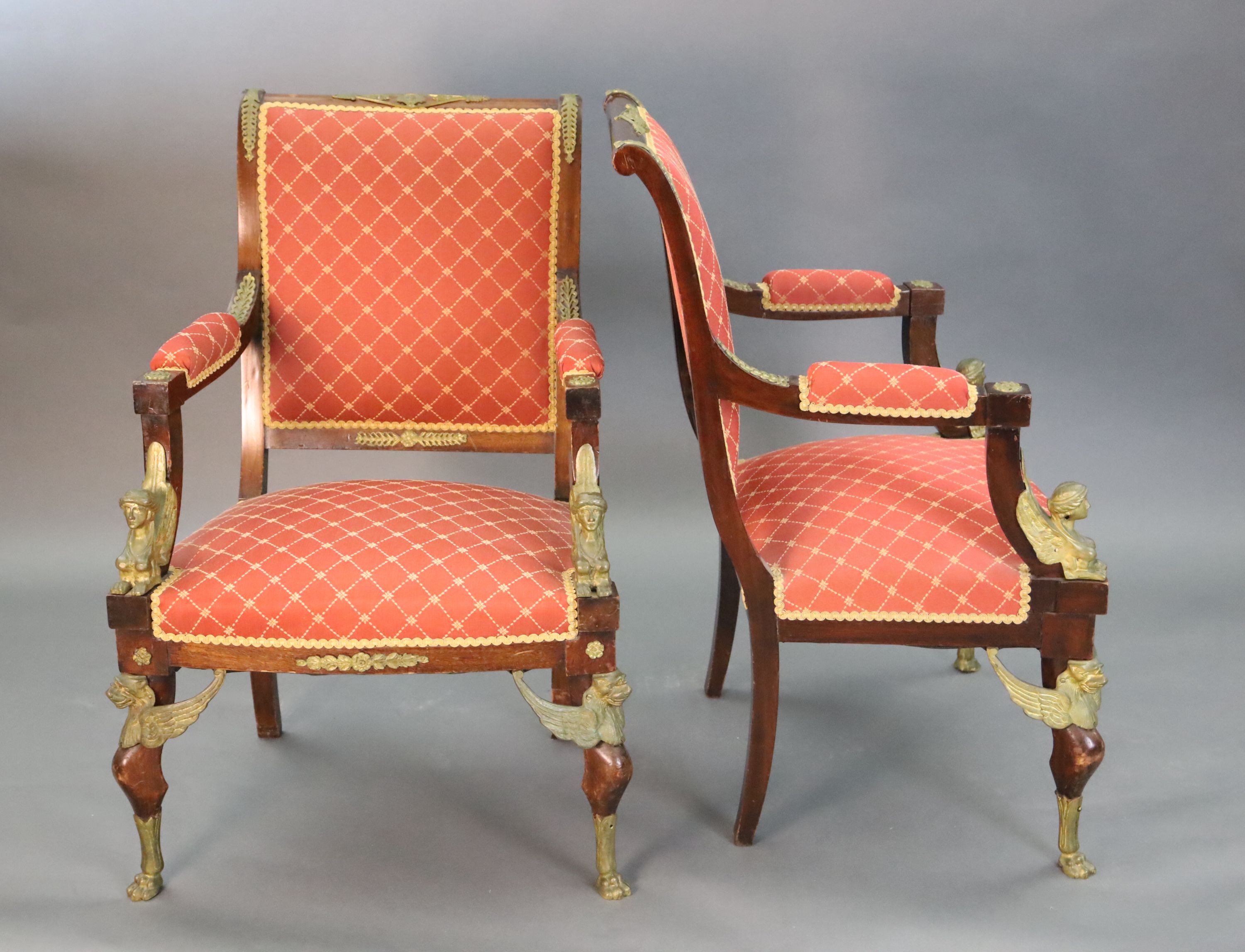 A late 19th century French Empire style ormolu mounted mahogany three piece salon suite, settee W.4ft 7in. D.2ft 5in. H.3ft 6in.